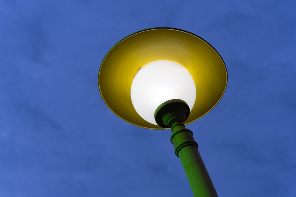Bright street lamp in Baku, Azerbaijan, glowing warmly against the evening sky.