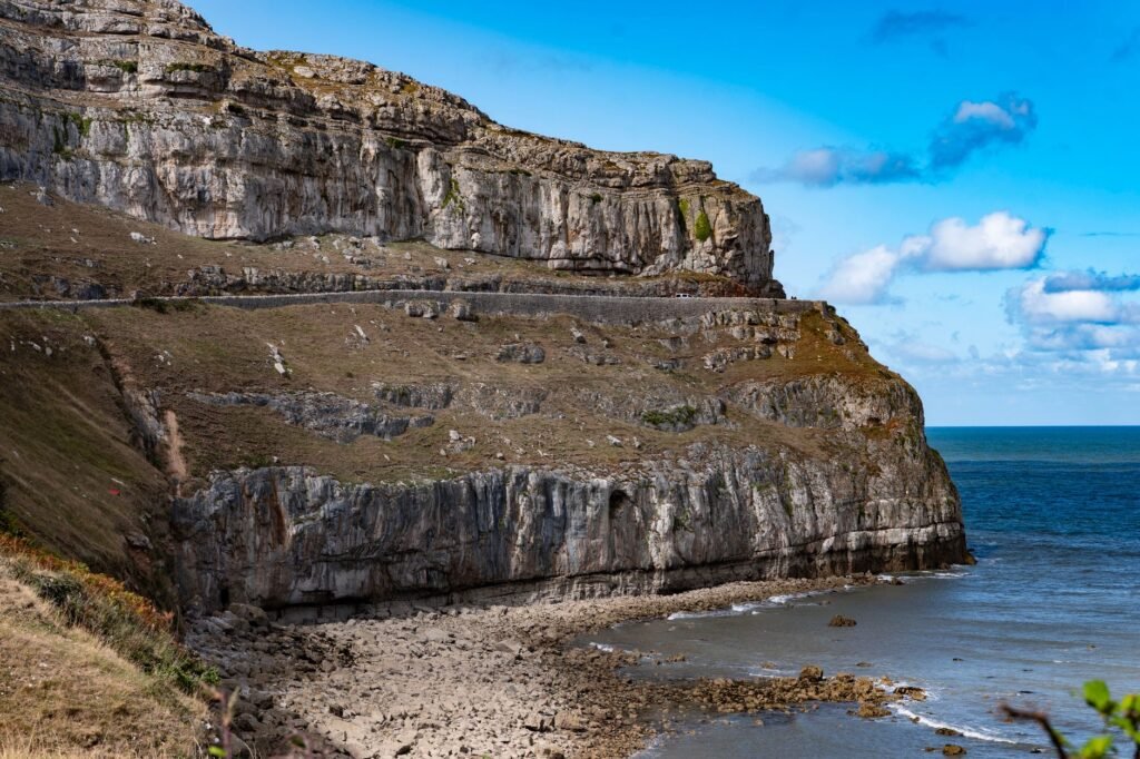 Breathtaking view of Great Orme's rugged cliffside and coastline in Llandudno, Wales.