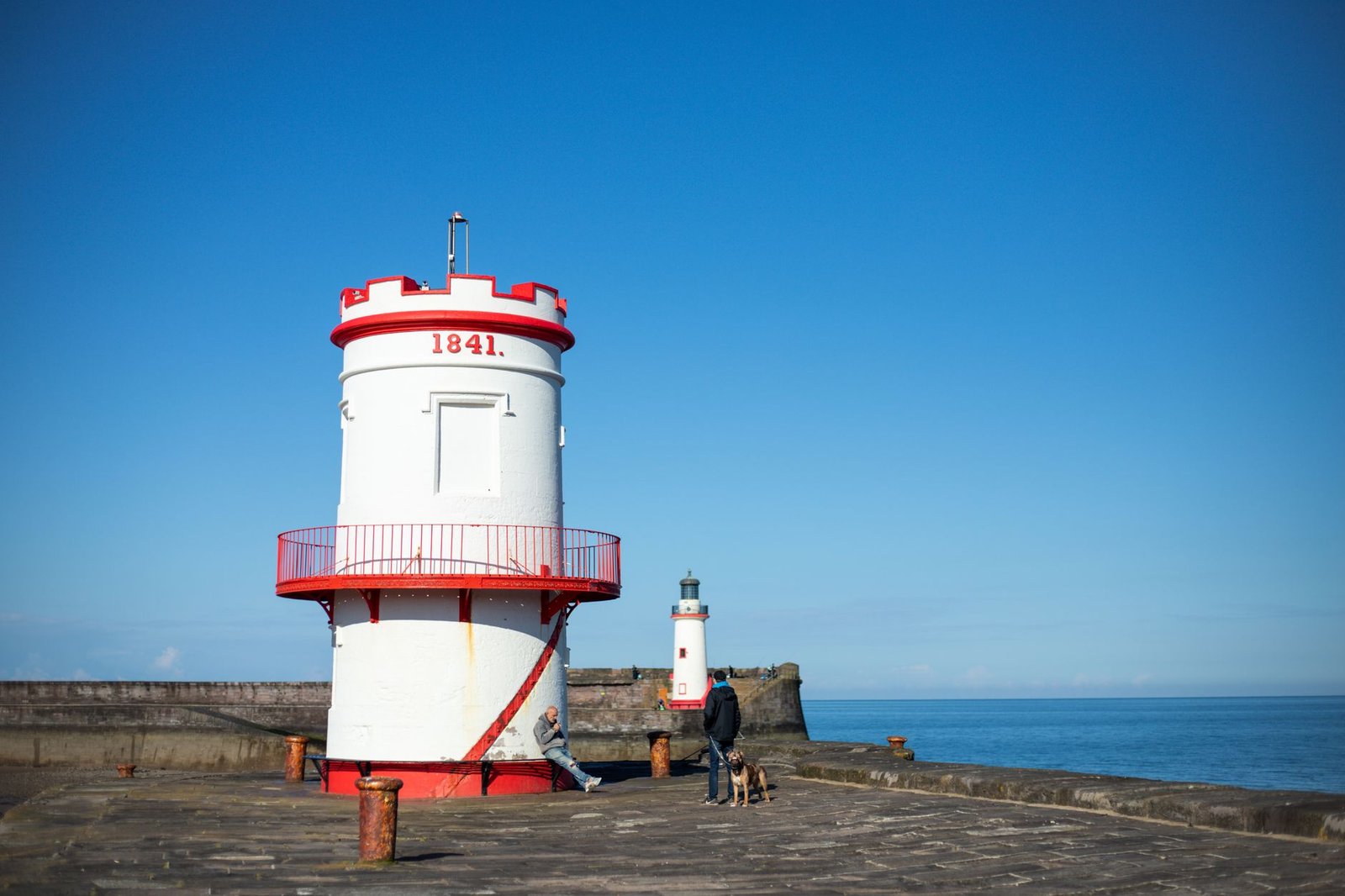 A beautifully captured view of Whitehaven Lighthouse with a clear blue sky, illustrating coastal charm and maritime history.
