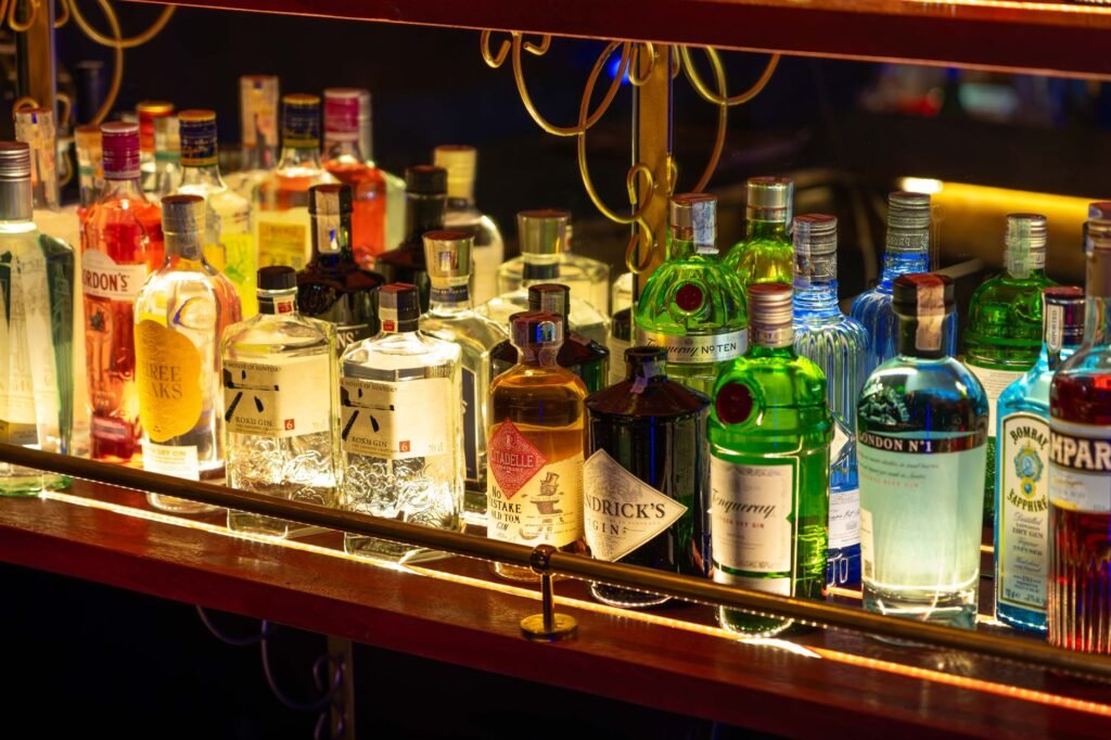 A colorful array of liquor bottles illuminated on a bar shelf, capturing a lively nightlife ambiance.