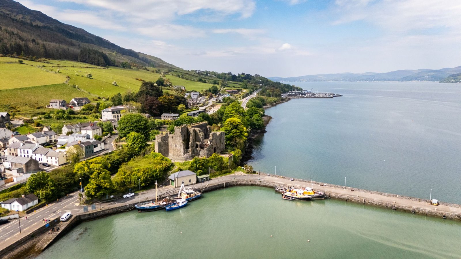 Stunning aerial view of Carlingford Castle and the surrounding harbor in Ireland on a clear day.