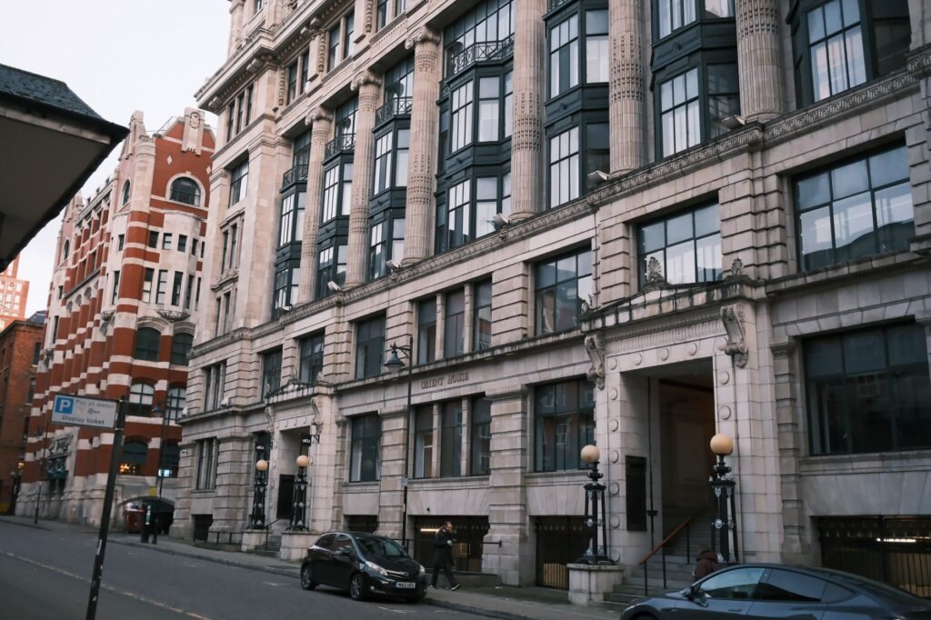 Street view featuring historic architecture and cars in a city setting.