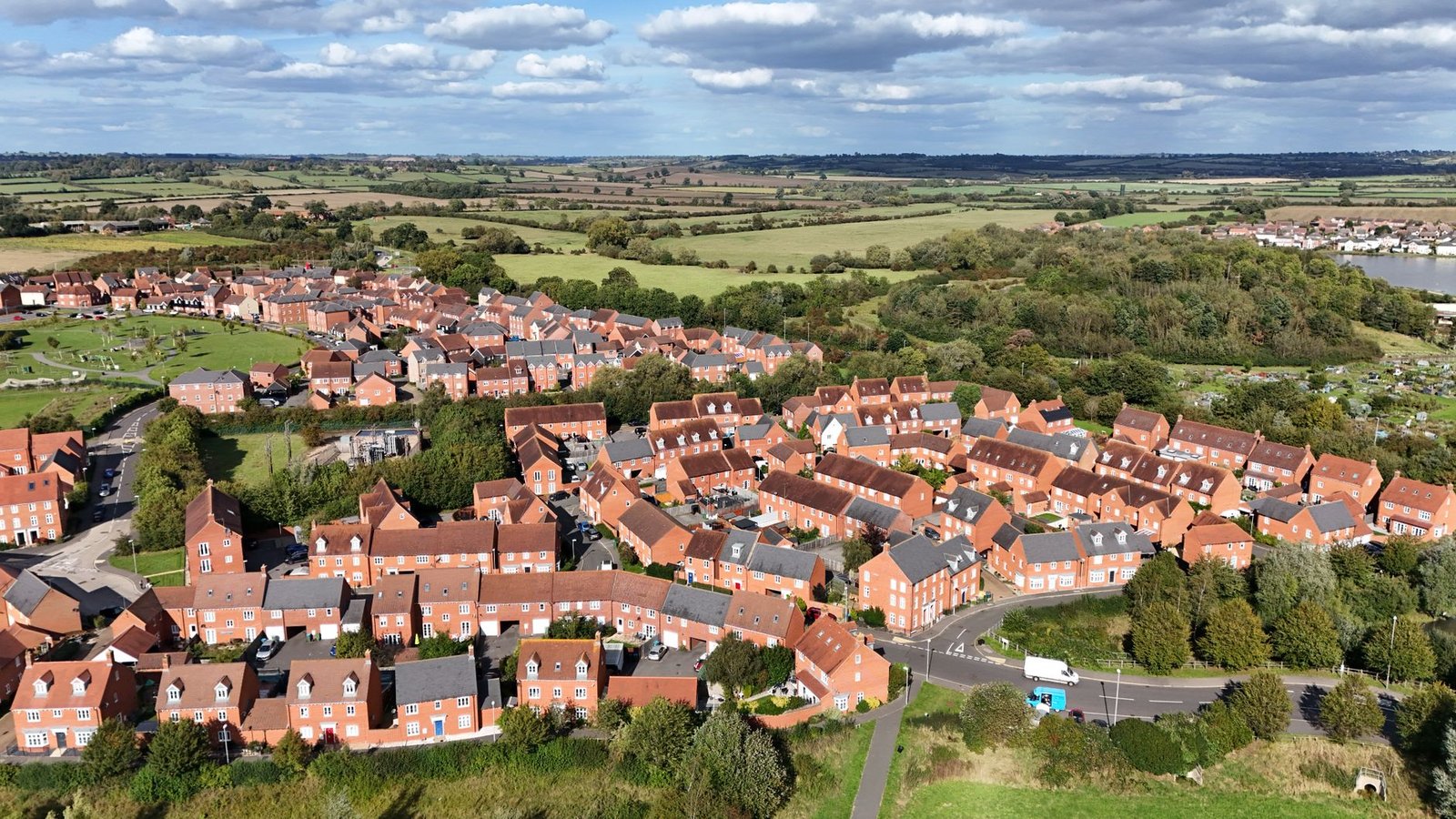A stunning aerial view of residential housing in Aylesbury, England surrounded by lush landscapes.