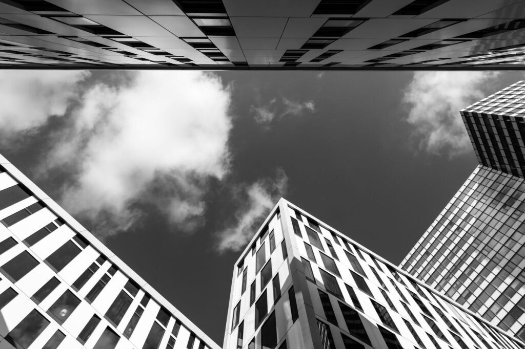 Dynamic low angle view of modern architecture in Hamburg under a cloudy sky.