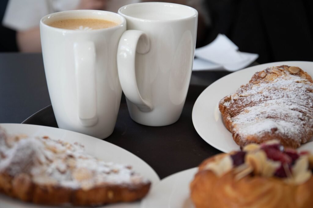 Delicious coffee and croissants served on a cozy cafe table, perfect for breakfast indulgence.