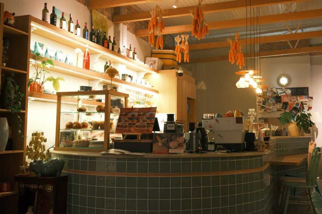 Inviting coffee shop interior with pastries and warm ambient lighting, offering a cozy atmosphere.