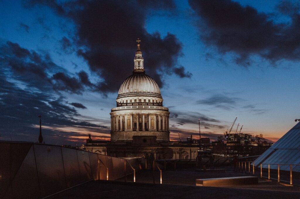 Experience the iconic dome of St. Paul's Cathedral in London under a dramatic sunset sky.