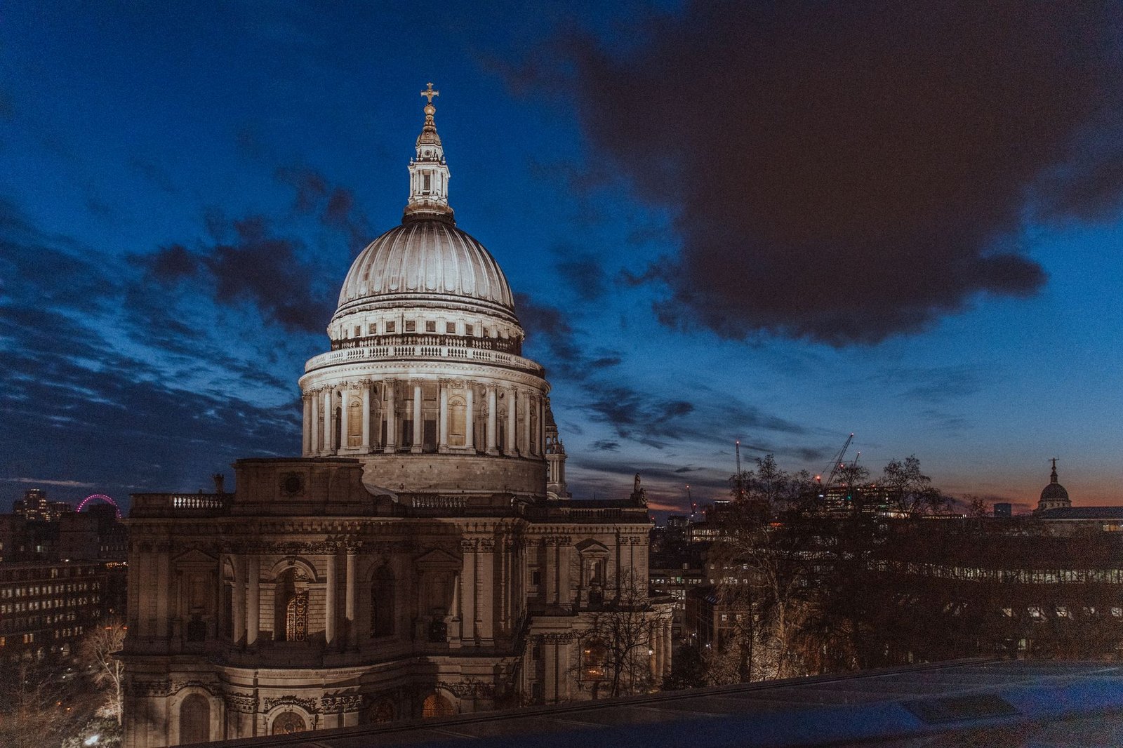 Beautiful nighttime cityscape featuring St. Paul's Cathedral in London with an illuminated skyline.