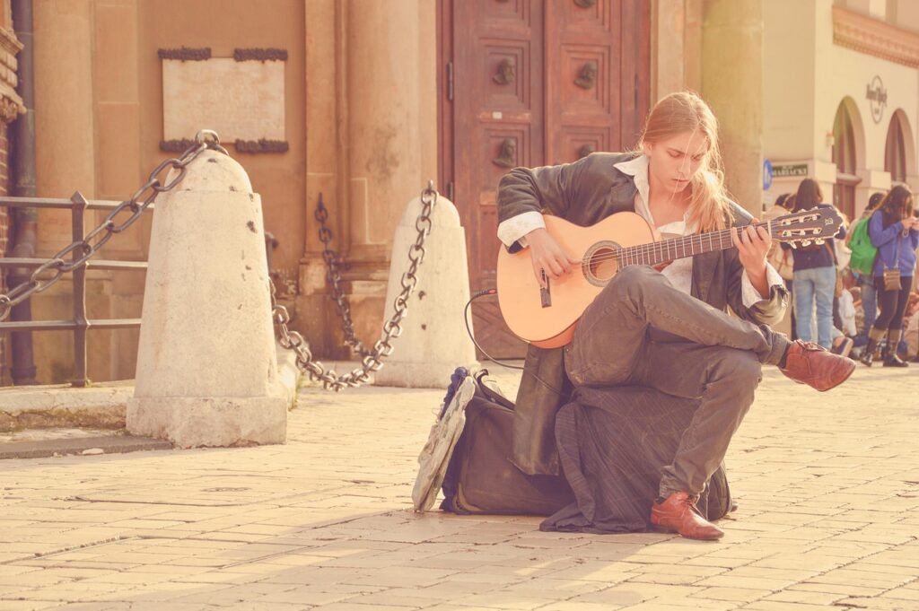 guitarist, street performer, man, playing music, playing guitar, acoustic guitar, blonde man, long hair, music, musician, pla