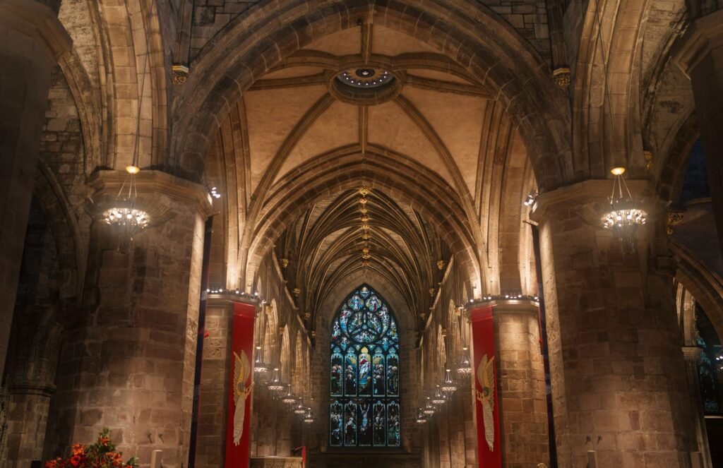 Interior view showcasing the Gothic arches and stained glass of Edinburgh Cathedral.