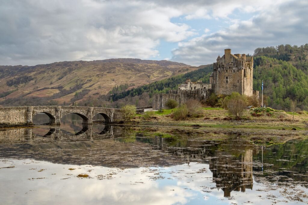 Scenic capture of Eilean Donan Castle reflecting in calm waters in Dornie, Scotland.