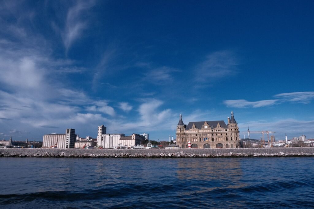 Stunning view of historic architecture along Istanbul's waterfront under a vibrant blue sky.