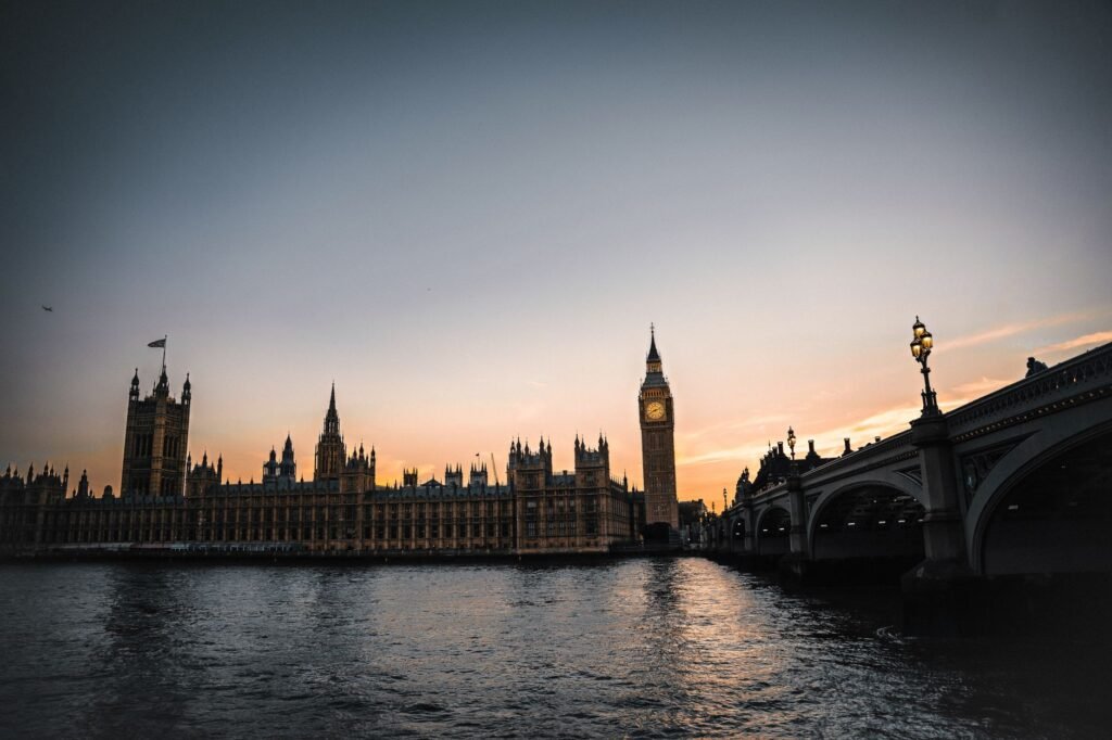 Stunning view of Big Ben and Westminster Bridge over the Thames River at sunset in London.