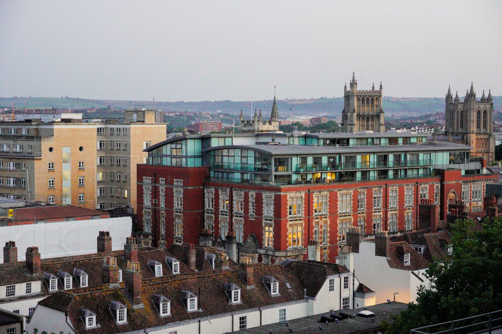 Discover the blend of modern and historic architecture in this vibrant cityscape at dusk.