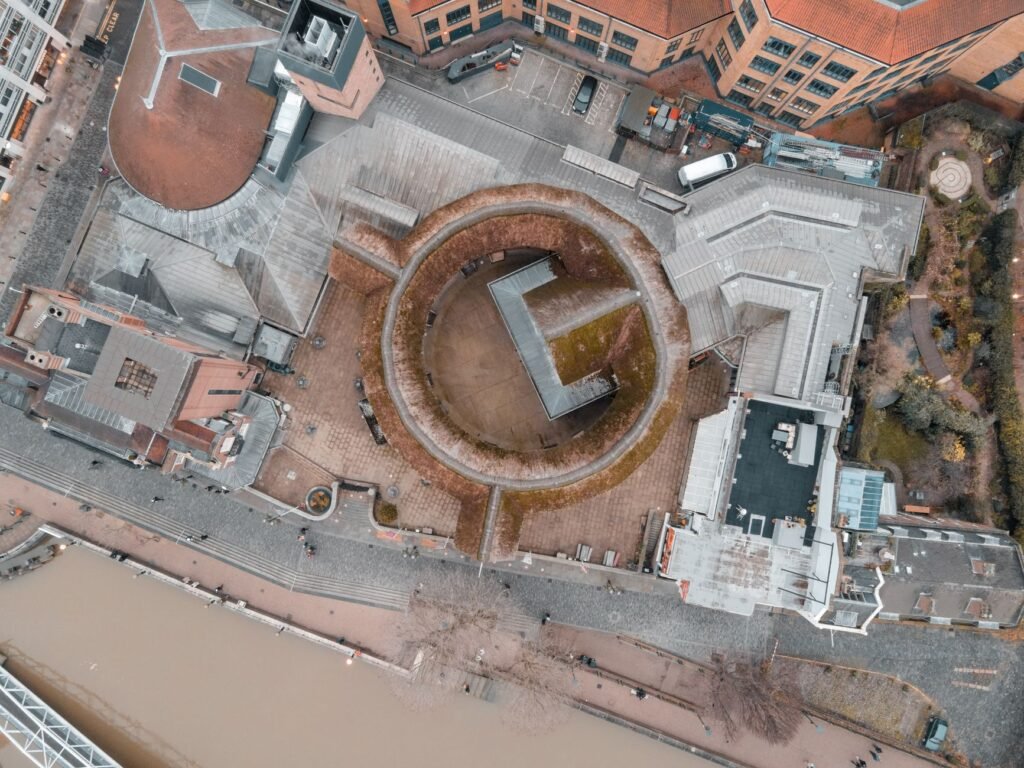 Aerial view of unique circular building design in London, showcasing urban architecture and city layout.