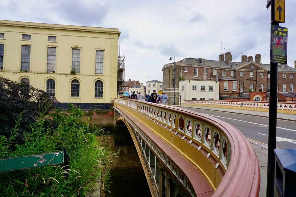 Charming street view of a historic bridge in Boston, England, under a cloudy sky.