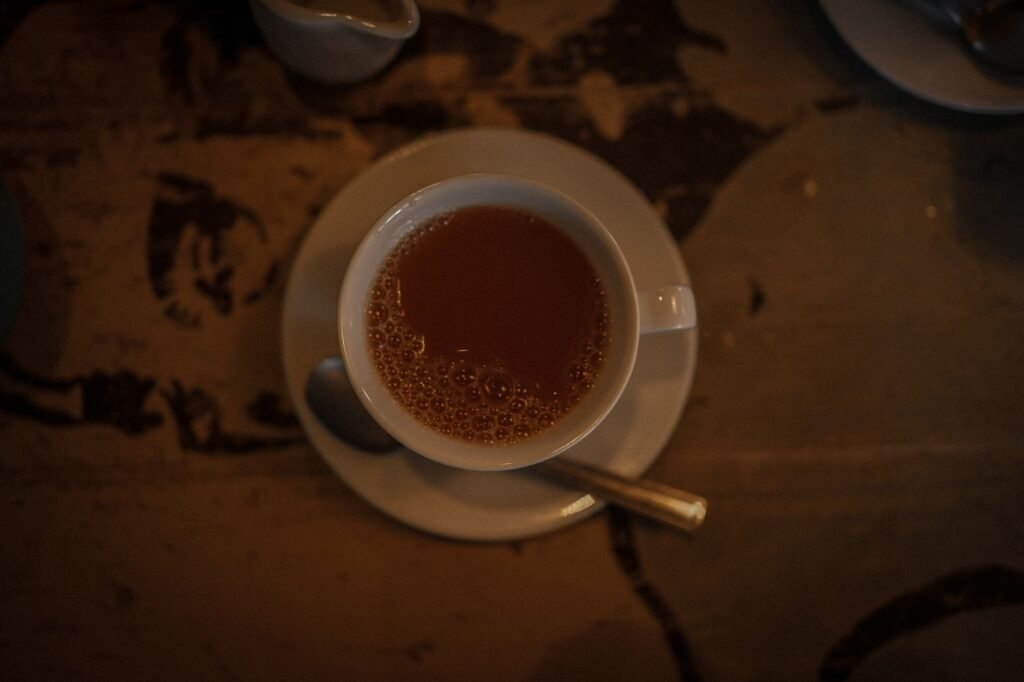 Warm and moody image of a tea cup on a rustic table, perfect for cozy themes.