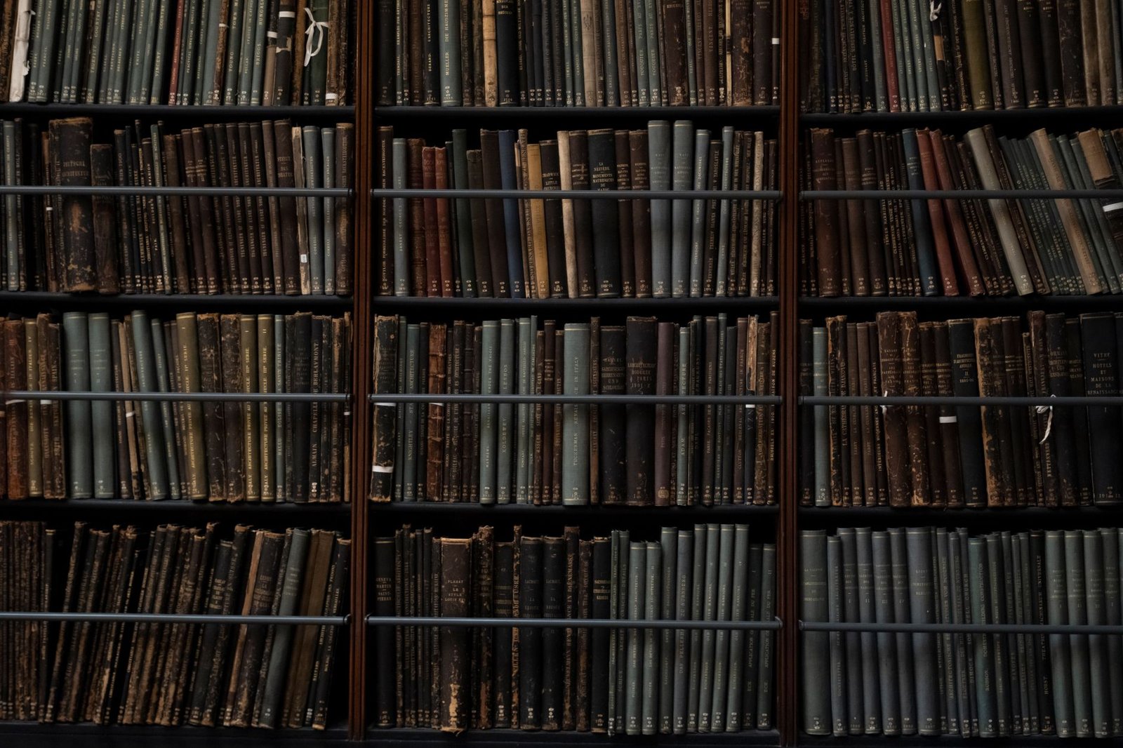 A close-up of vintage books on library shelves in London, showcasing an abundance of literary history.