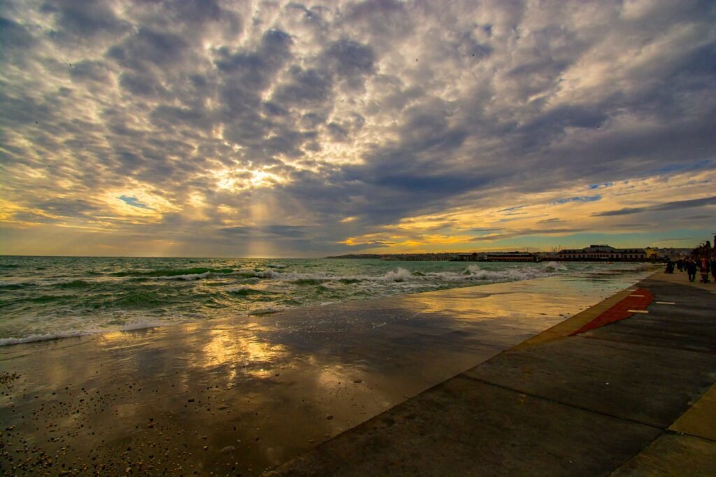 Mesmerizing sunset view over the sea at Büyükçekmece, Istanbul, with dramatic clouds and reflections.
