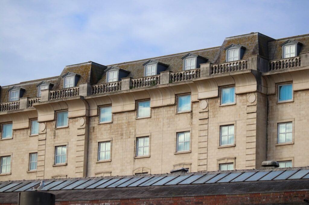 Elegant urban building facade featuring dormer windows and stone architecture, adding classical charm.