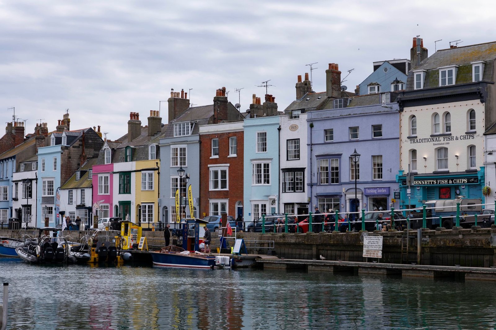 Colorful historic harborfront houses in Weymouth, England showcasing vibrant architectural charm.