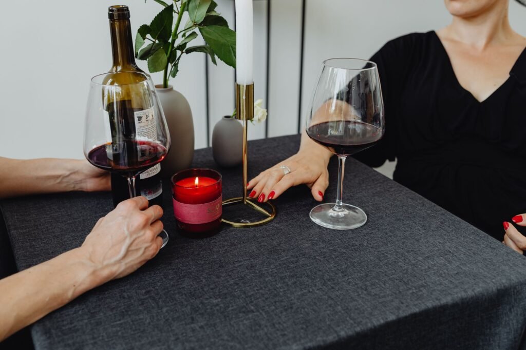 Intimate dinner with red wine and candles, perfect for a romantic evening.