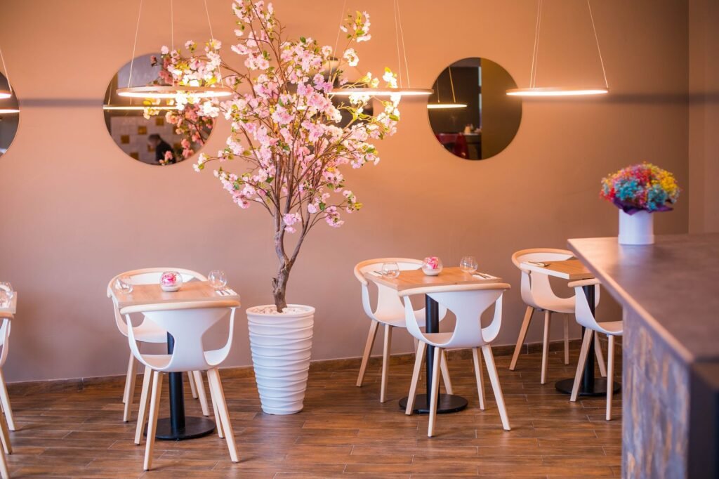 Stylish restaurant interior featuring cherry blossom decor and modern furniture design.