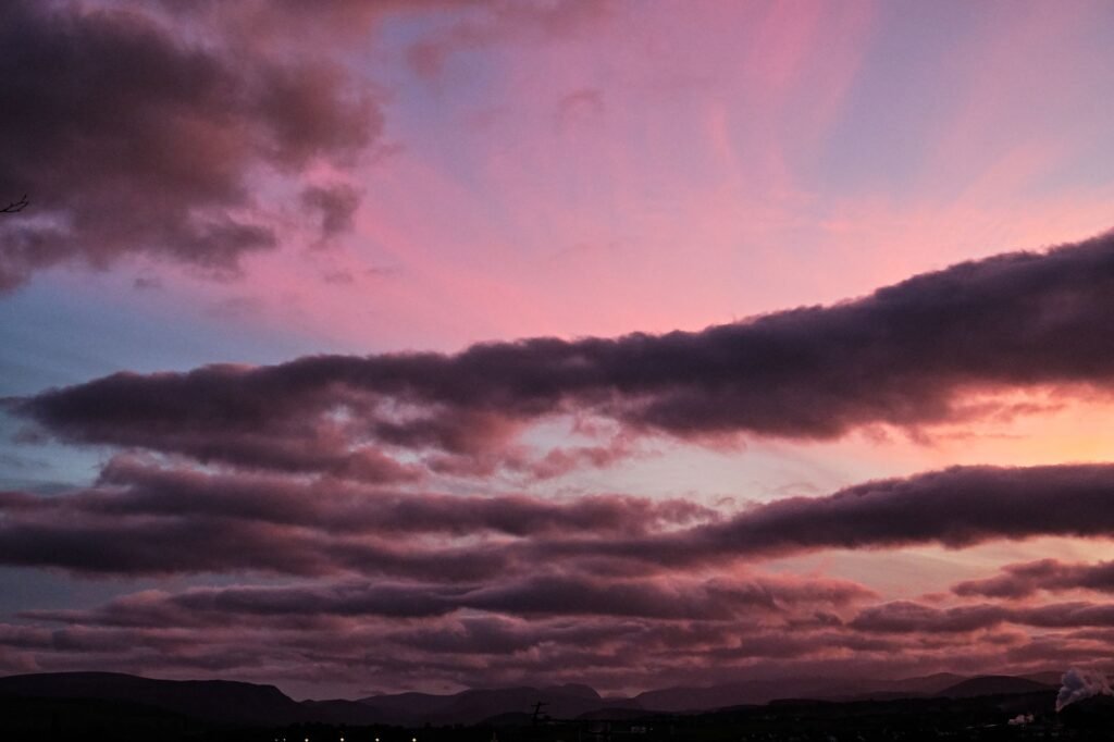 Stunning cloudscape at dusk in Penrith, England, showcasing pink and purple hues.