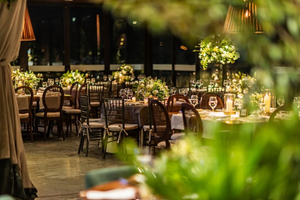A beautifully decorated dining area in a luxury restaurant with elegant table settings and floral arrangements.