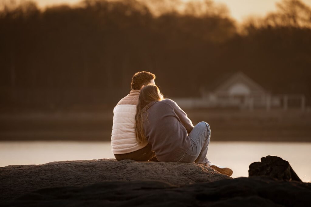 A romantic moment as a couple enjoys the sunrise at Cove Island Park, Stamford, Connecticut.