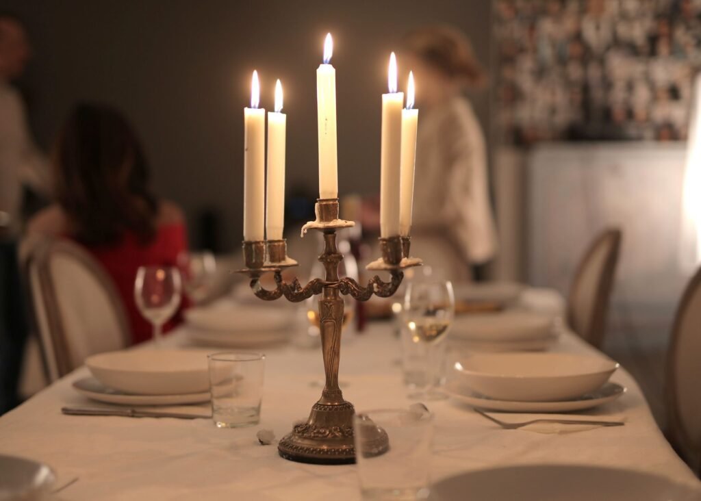 A beautifully arranged dinner table with candles creating a warm ambiance indoors.