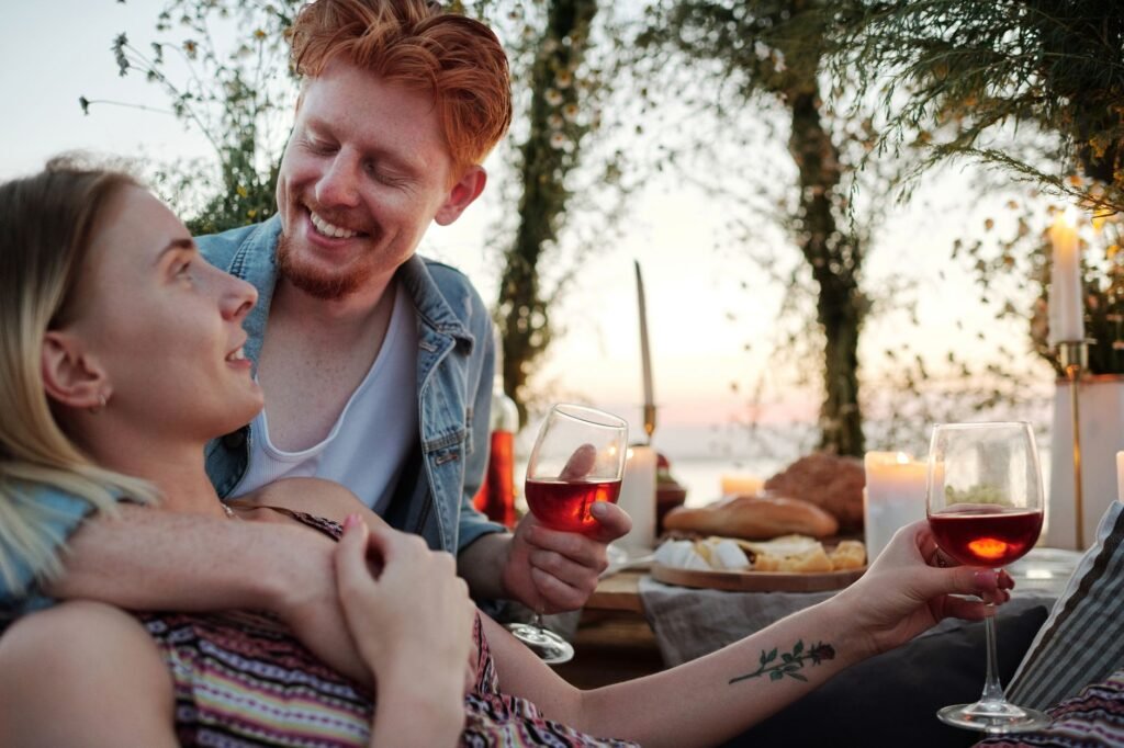 Smiling couple caressing while smiling and looking at each other during romantic date