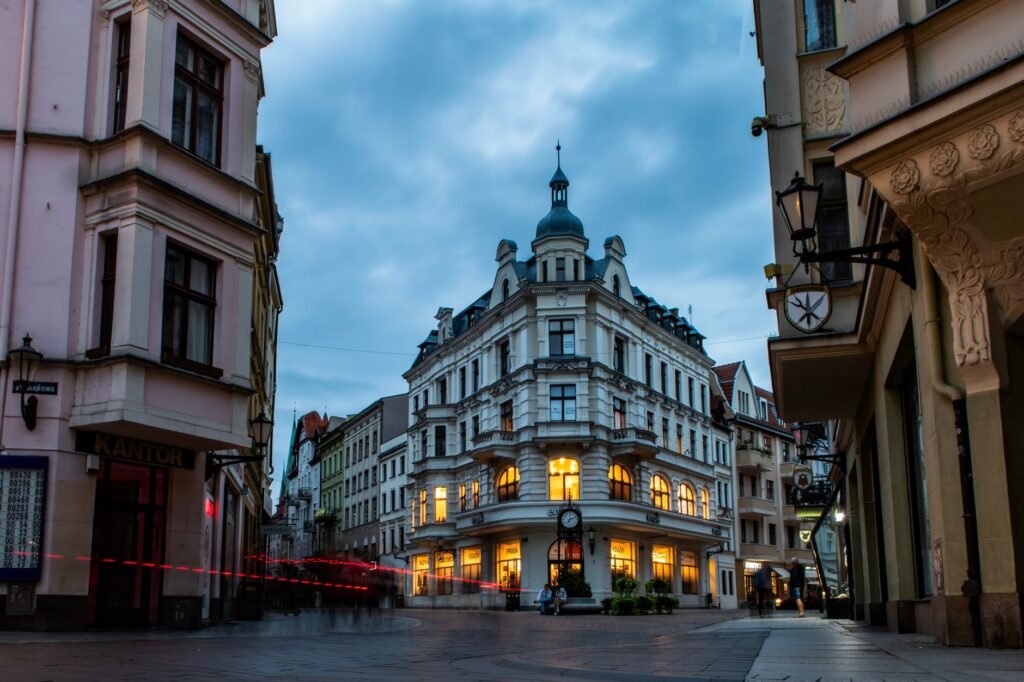 Charming European street scene with historic architecture and warm evening lights.