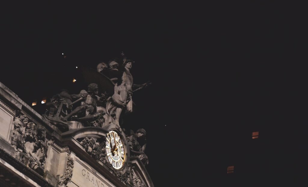 Night view of Grand Central Terminal's clock and sculptures, New York City.