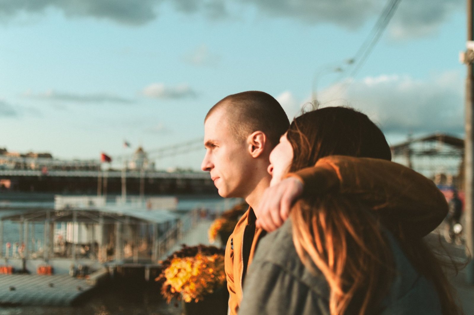 A couple embraces by the waterfront, reflecting romance and togetherness.