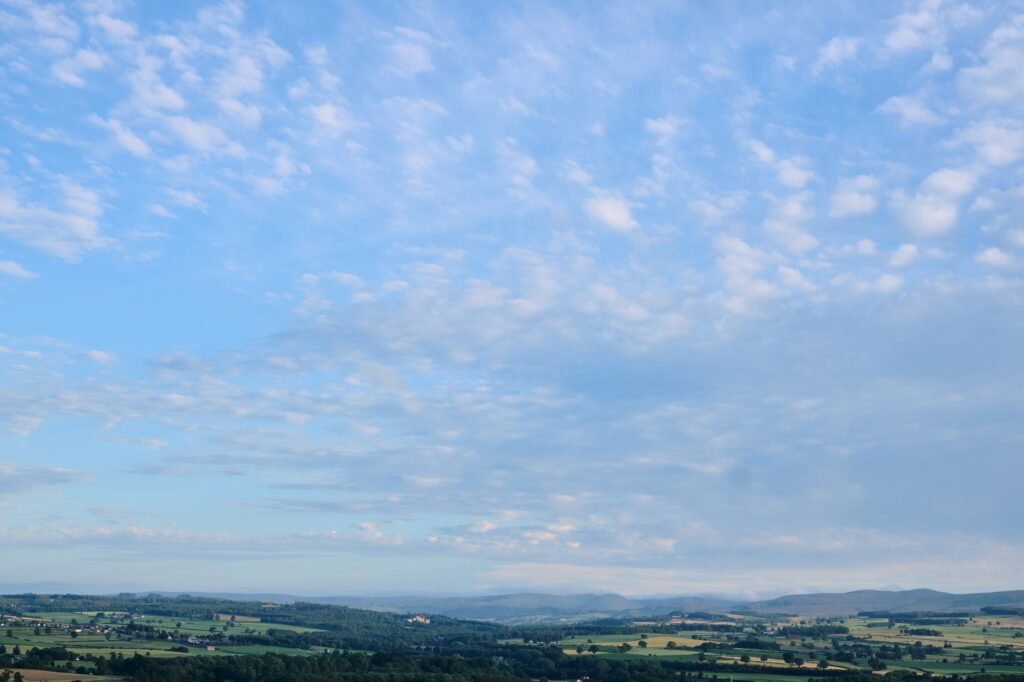 Aerial view of Penrith's picturesque countryside with vast blue skies and rolling hills.