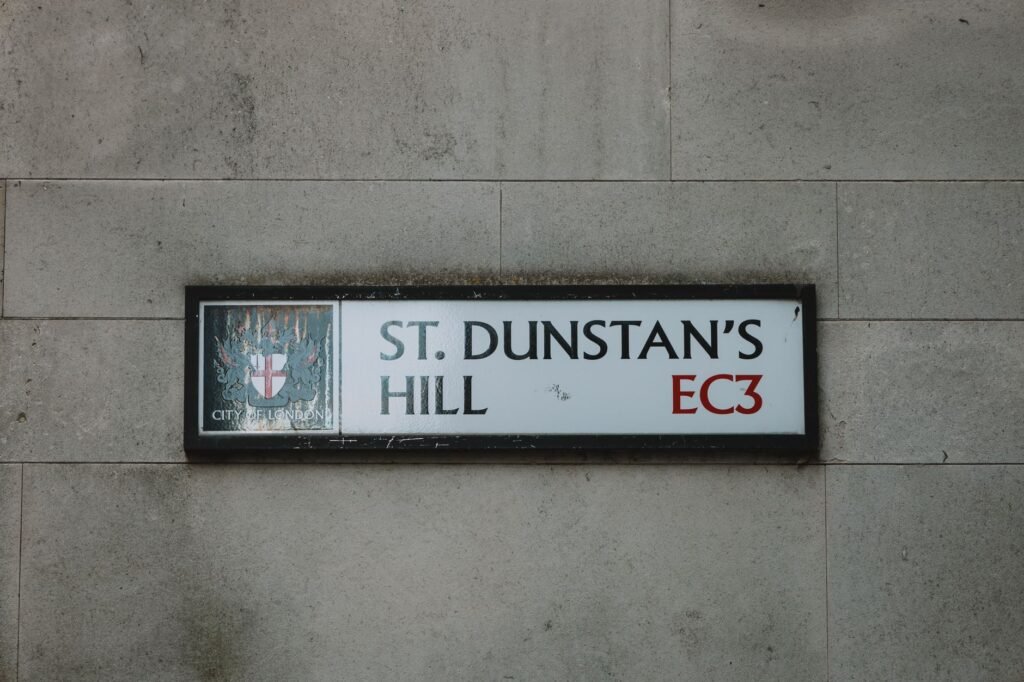 Close-up image of St. Dunstan's Hill street sign in London, highlighting urban architecture.