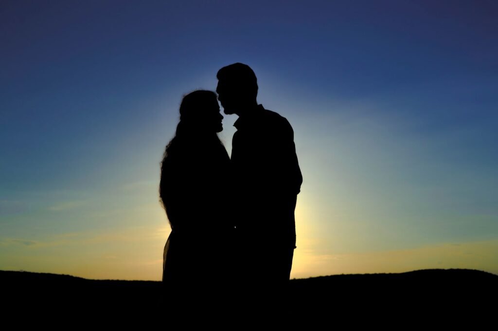 Silhouette of a couple embracing at sunrise, creating a romantic mood in Hyderabad.
