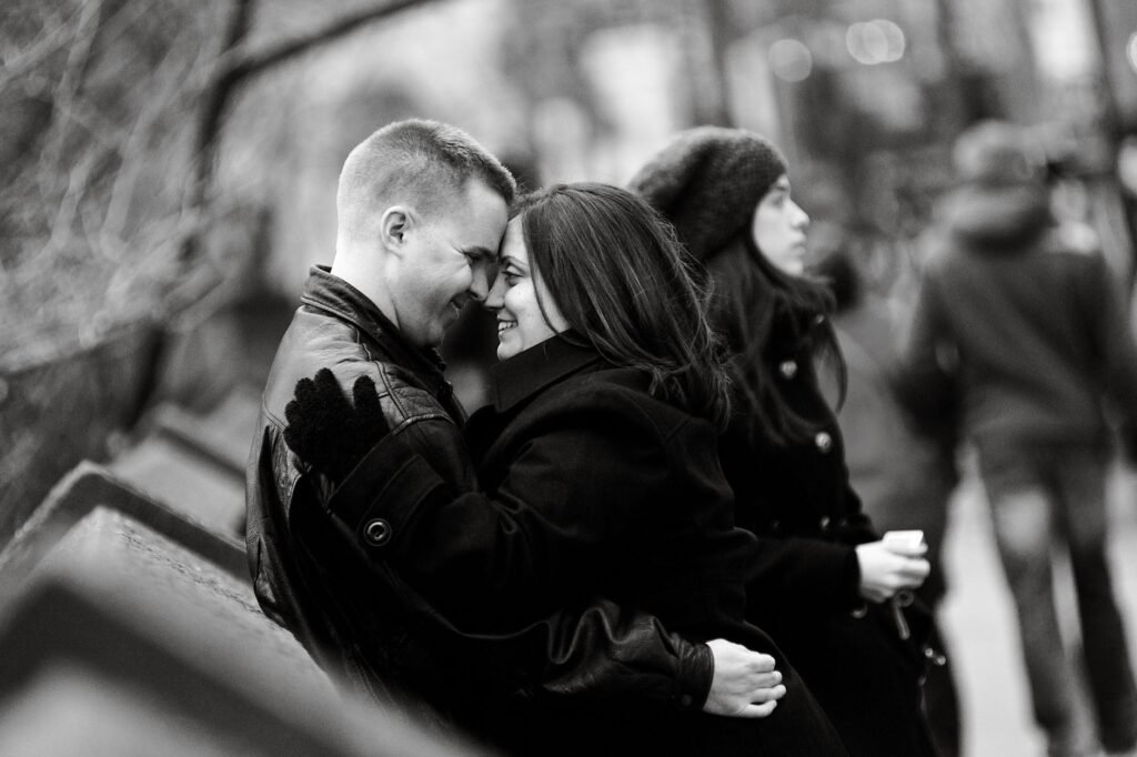 Couple sharing a romantic moment outdoors in black and white, New York City.