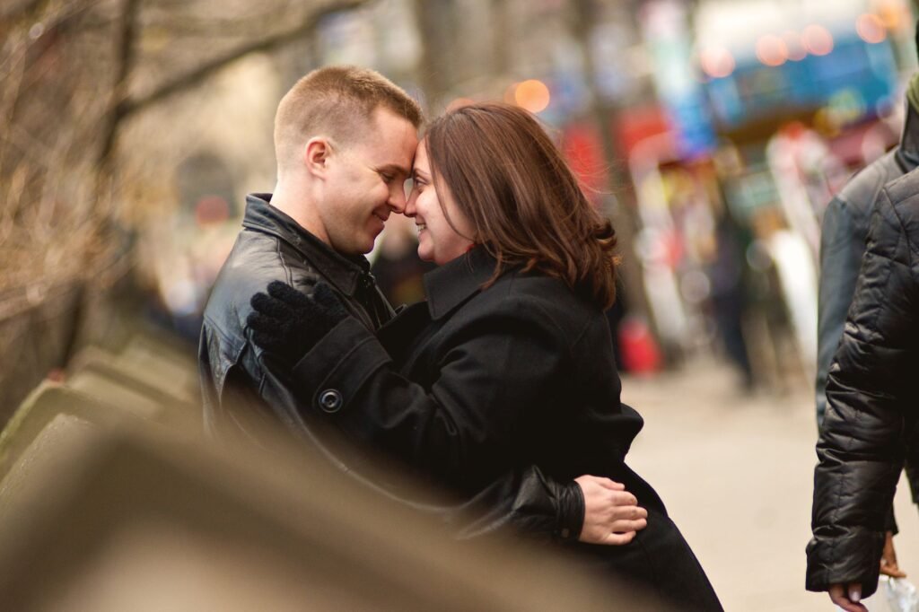 Loving couple sharing an intimate moment on a New York City street during fall.