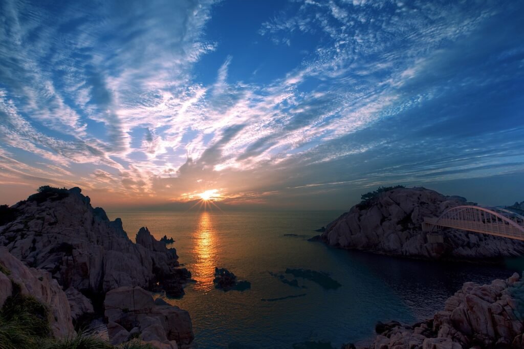 sea, mountains, sunrise, sunset, sun, sunlight, reflection, cliffs, coast, coastline, clouds, horizon, bridge, rock formation