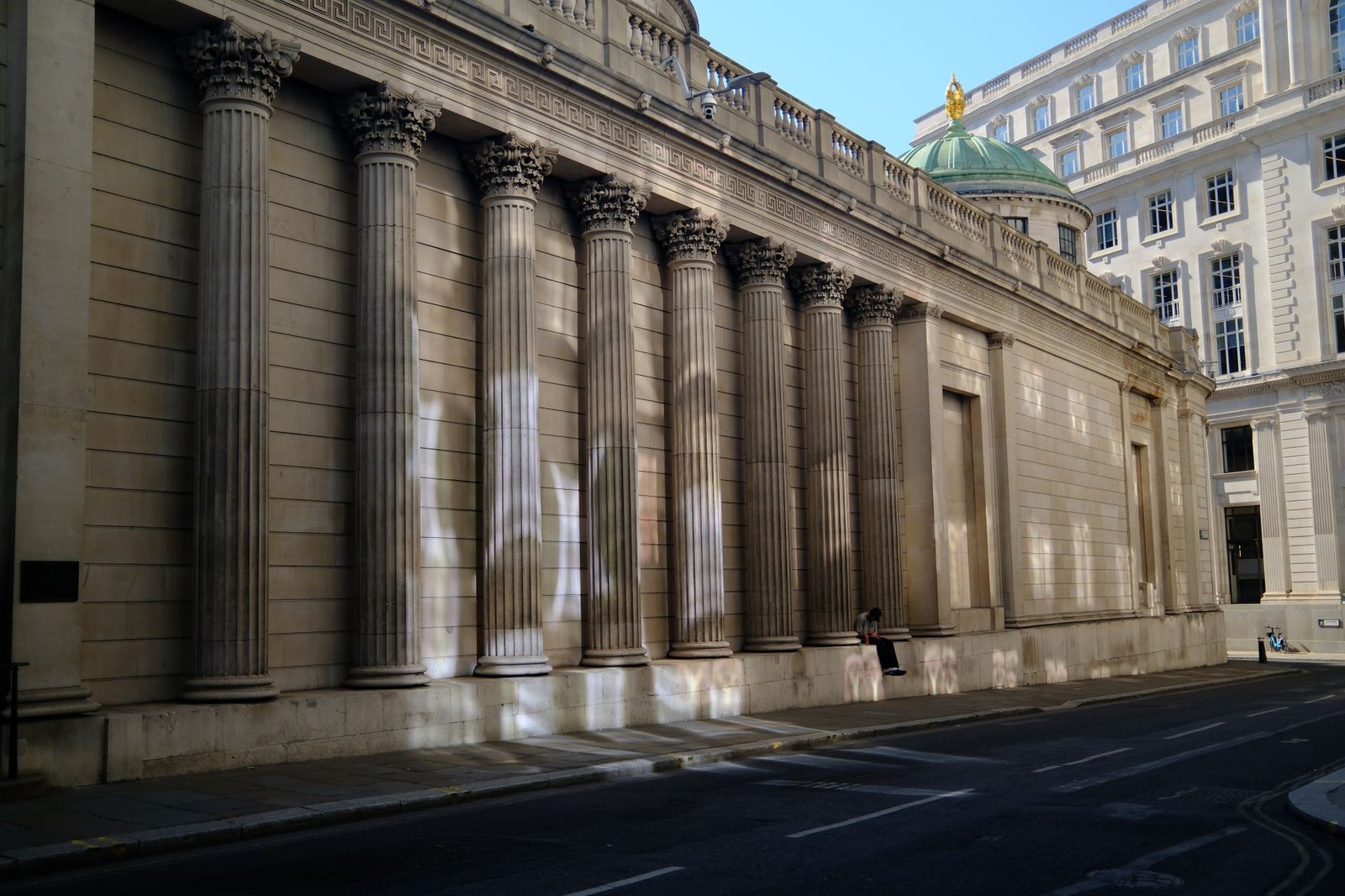 Neoclassical architecture of a historic building in London, featuring grand columns and urban setting in daylight.