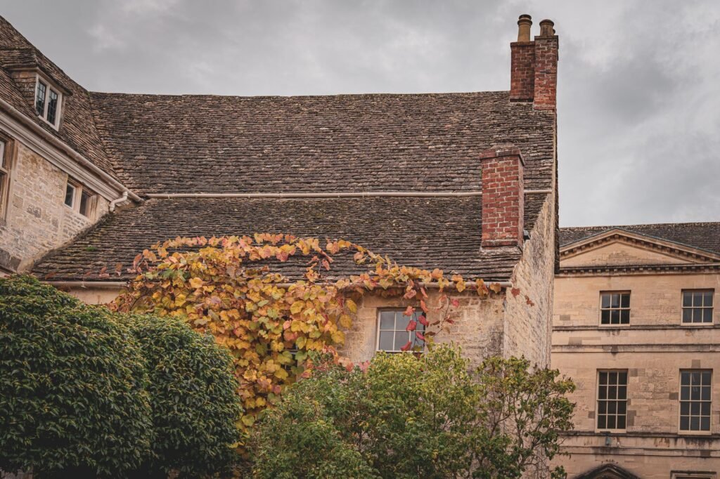 A picturesque stone building in England with classic architecture and ivy-covered walls.