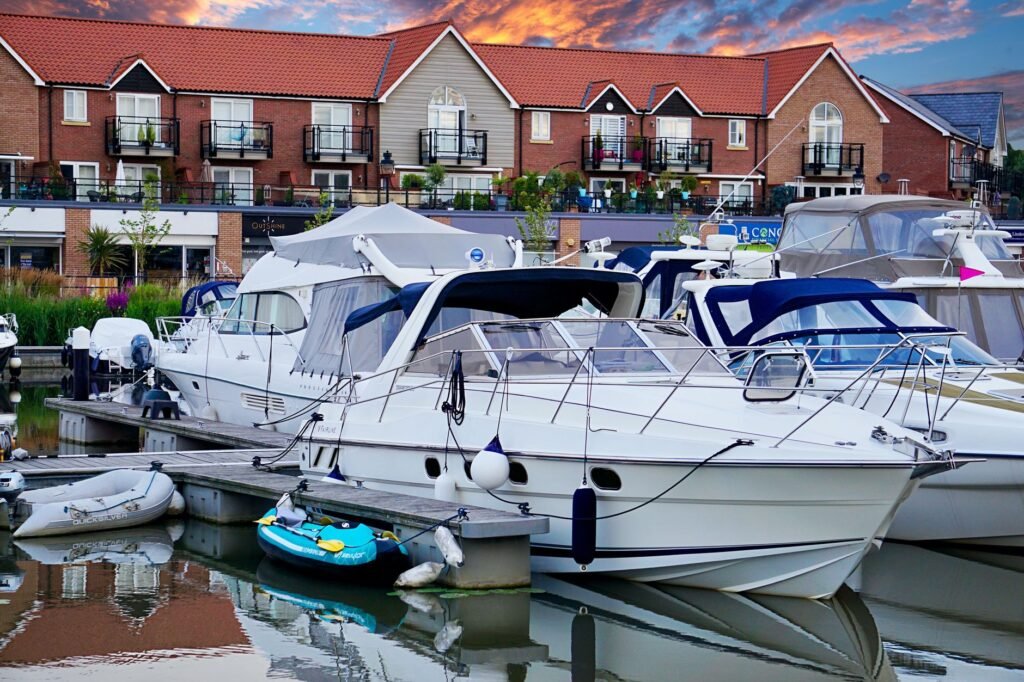 Scenic view of luxury yachts docked at a marina with beautiful sunset in England.