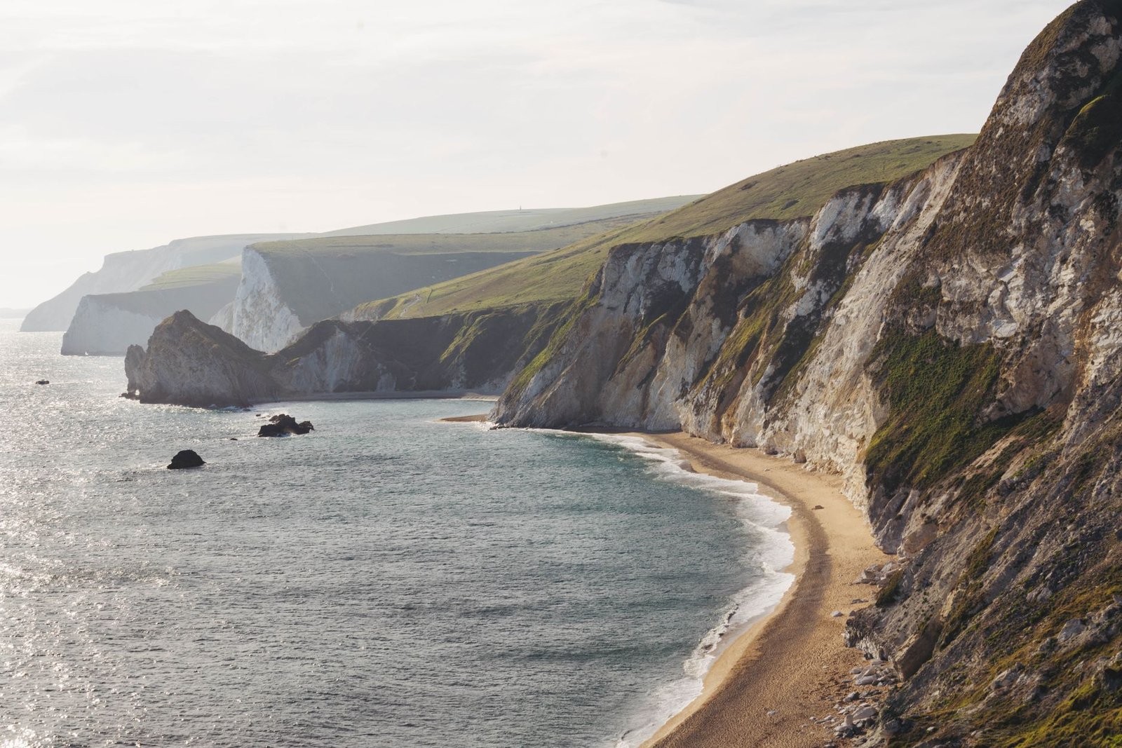Explore the breathtaking beauty of rugged cliffs overlooking a serene coastline.