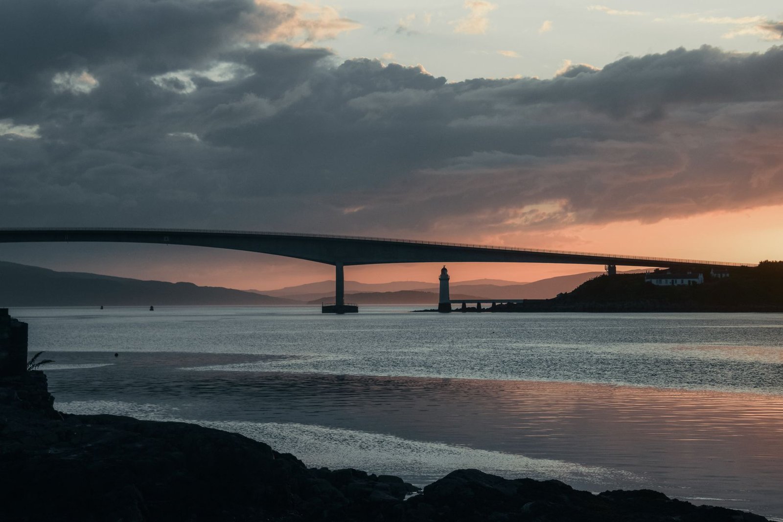 Scenic view of Skye Bridge and lighthouse during a stunning sunset.