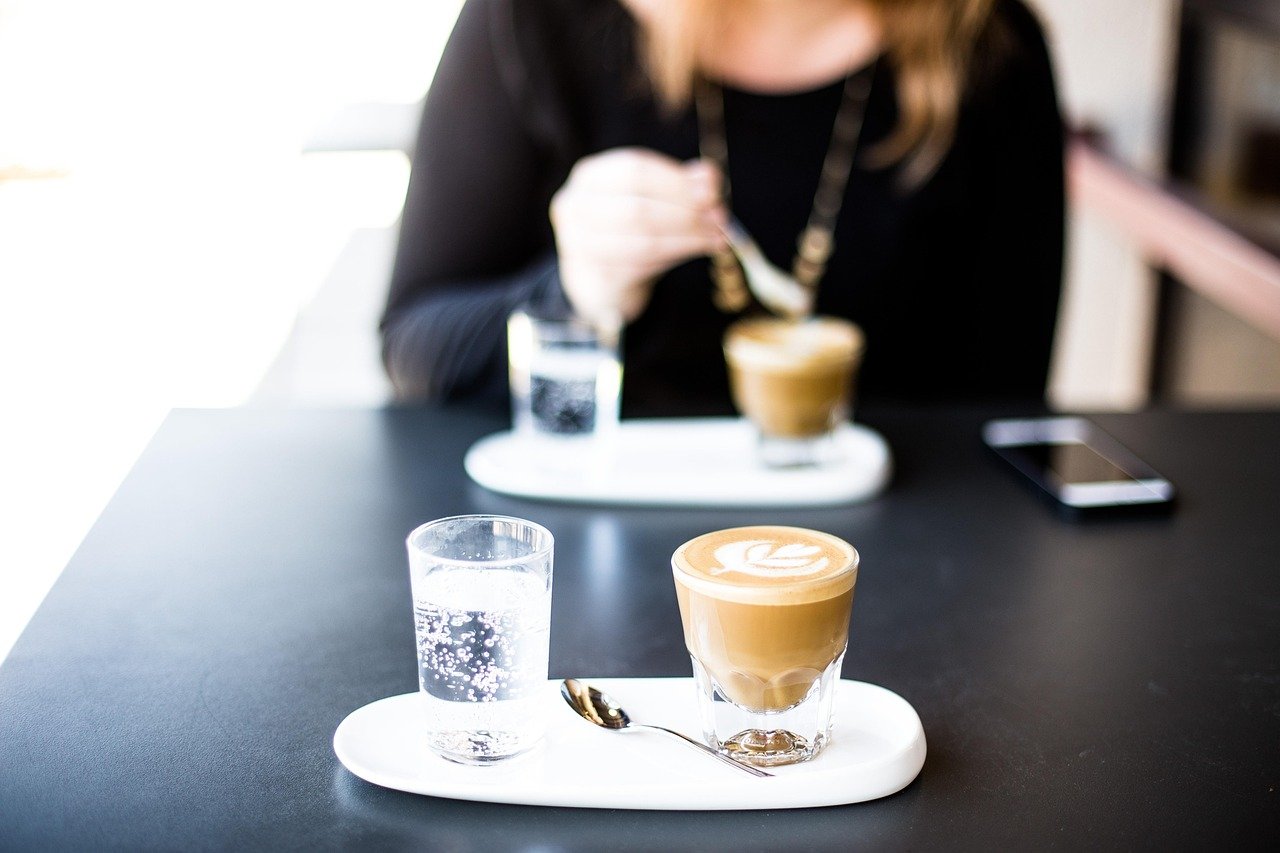 cafe, bar, coffee cup, restaurant, coffee, breakfast, cappuccino, cup, drink, glass, indoors, latte, person, plate, table