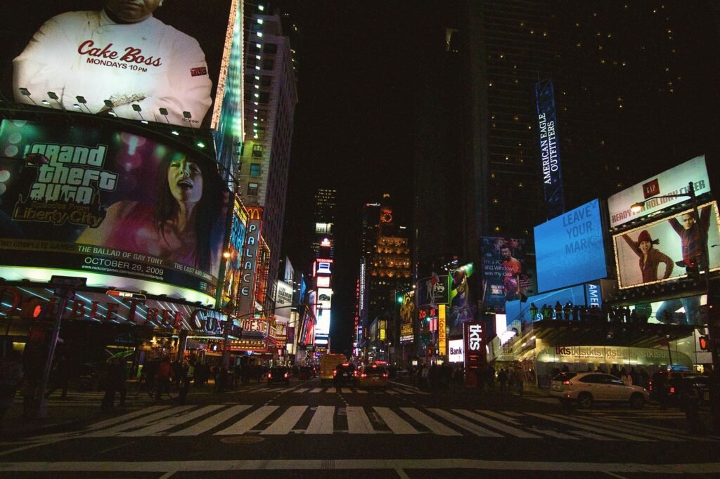 Dynamic and colorful nighttime view of Times Square, New York City, bustling with illuminated billboards and lights.