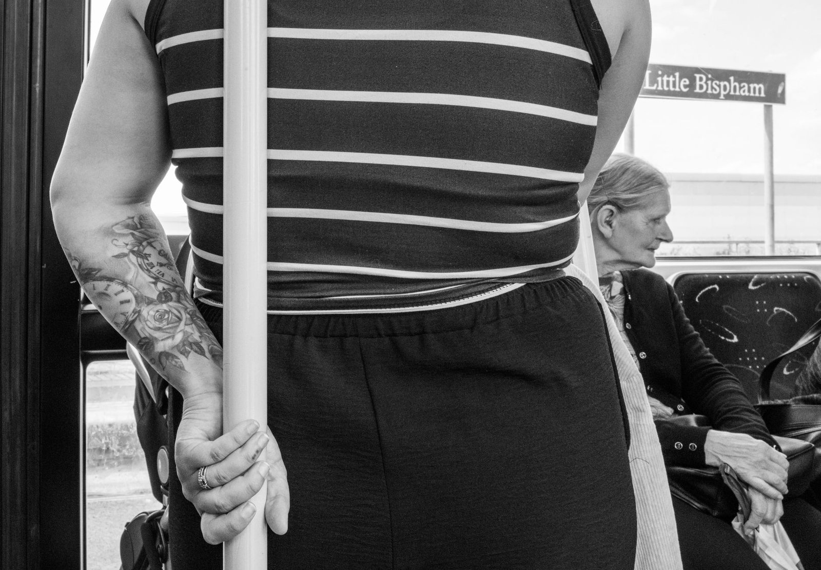 Candid street photography on a tram in Blackpool featuring diverse passengers.