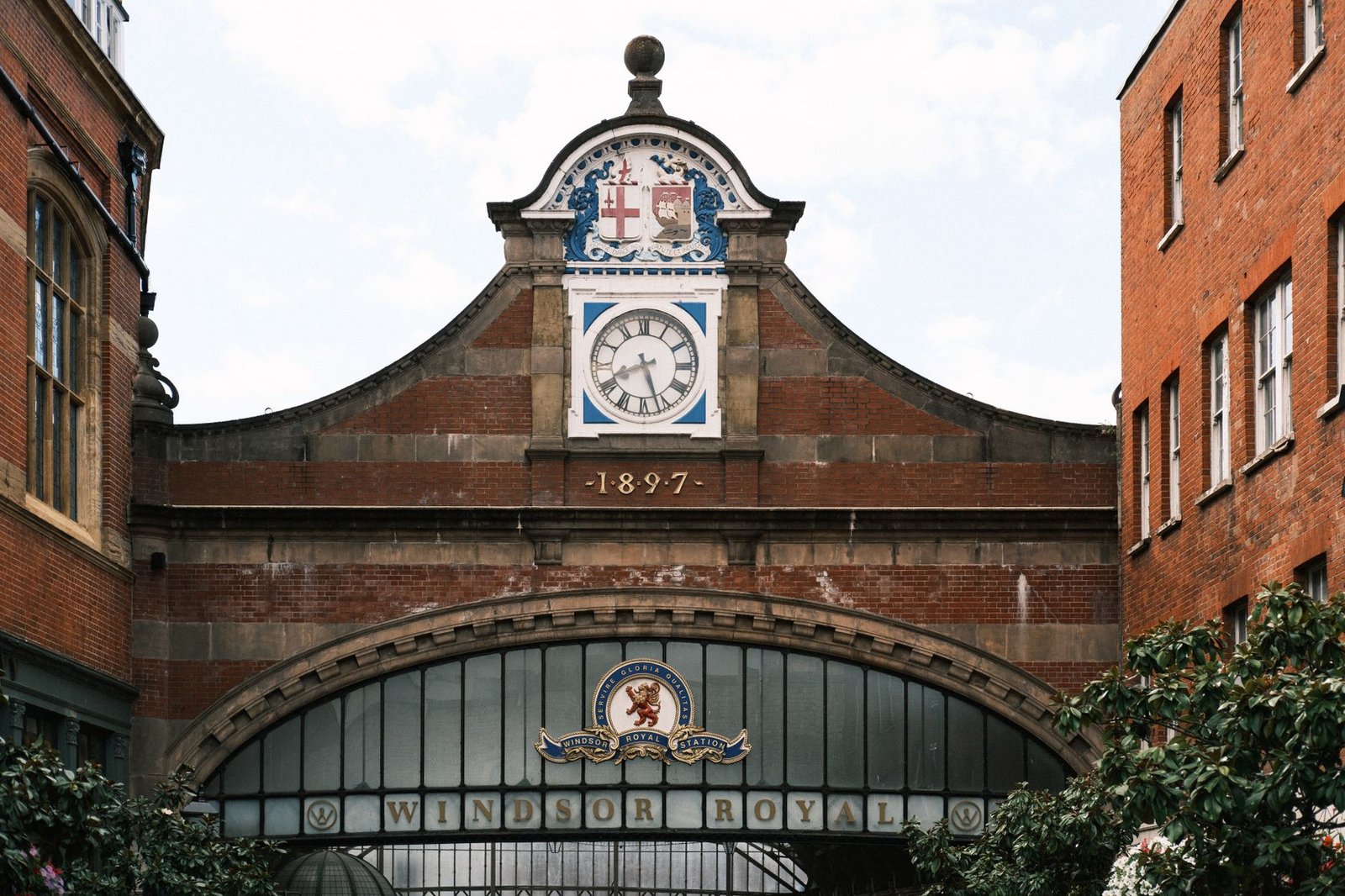 Historic facade of Windsor Royal Station, showcasing clock and architectural details in London.